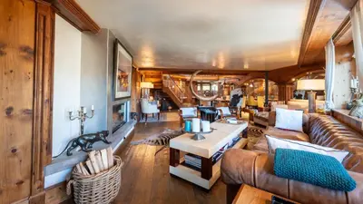 a living room with a couch and a table at Chalet Fenice by My Villa Collection in Cortina dʼAmpezzo