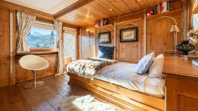 a bedroom with a bed in a wooden room at Chalet Fenice by My Villa Collection in Cortina dʼAmpezzo