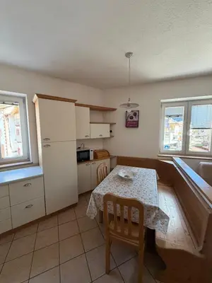 a bedroom with a bed and a desk in it at Casa Lilla Predazzo in Predazzo
