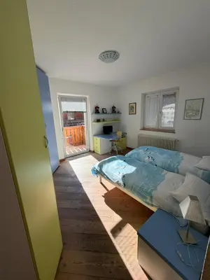 a door to a closet with shelves in it at Casa Lilla Predazzo in Predazzo