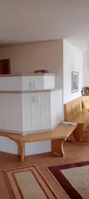 a room with a table and a bench in a room at Casa Lilium in Daiano