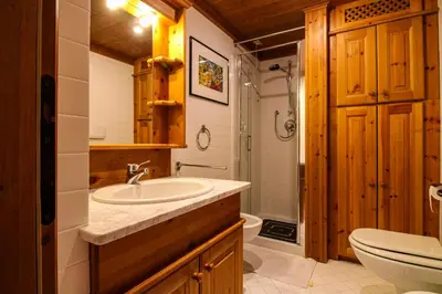 a bathroom with a sink and a toilet at Cortina Wood Home - a short walk from the center in Cortina dʼAmpezzo