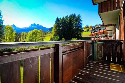 a wooden balcony with a view of the mountains at Cortina Wood Home - a short walk from the center in Cortina dʼAmpezzo