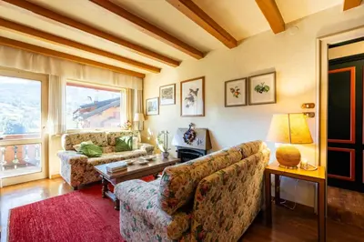 a living room with two couches and a table at Ca dei Castori in Cortina dʼAmpezzo