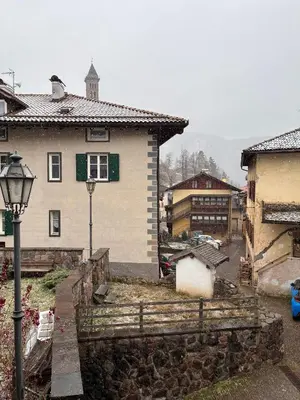 a house and a street light in a village at Ca' Stella in Castello di Fiemme