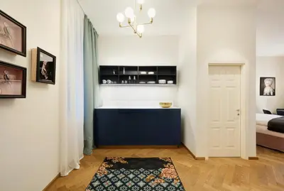 a living room with a blue cabinet and a bed at Park Residence Apartments in Bolzano
