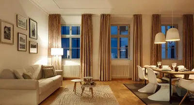 a living room with a couch and a dining room at Park Residence Apartments in Bolzano