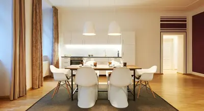 a kitchen and dining room with a table and chairs at Park Residence Apartments in Bolzano