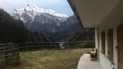 a view of a snowy mountain range from a house at Dolomite Nest in Cencenighe