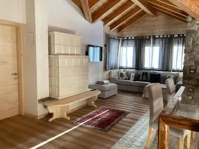 a large living room with a couch and a table at Dolomite Nest in Cencenighe