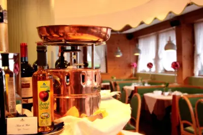 a juicer sitting on top of a table in a restaurant at Hotel Majoni in Cortina dʼAmpezzo