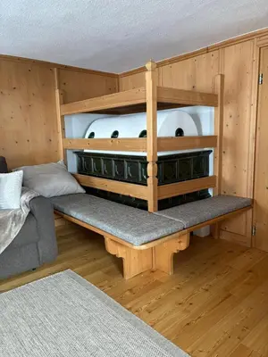 a bedroom with a large bed with white sheets and pillows at Hanselerhof in Val di Mezzo