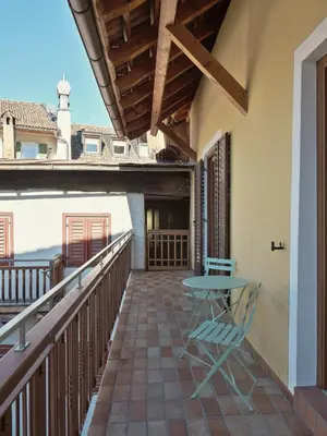 a patio with a table and chairs on a balcony at LIMIX Stays in Appiano sulla Strada del Vino