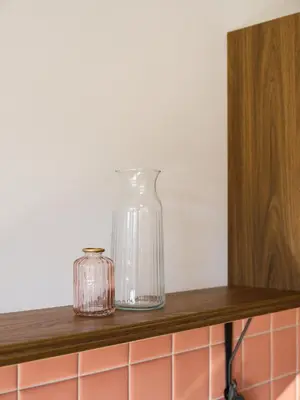 two glass vases sitting on a wooden shelf at LIMIX Stays in Appiano sulla Strada del Vino