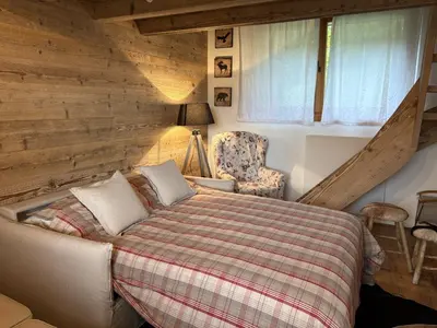 a bedroom with a bed and a chair and a window at Il Tabià
