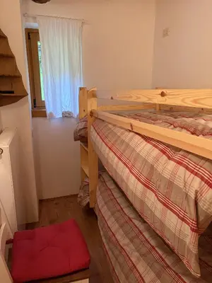 a bedroom with two bunk beds and a window at Il Tabià