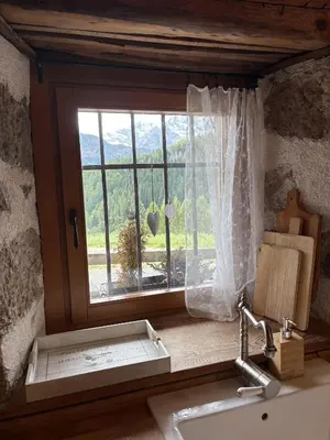 a kitchen with a window with a sink and a sink at Il Tabià