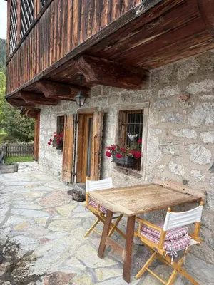 a wooden table and chairs in front of a building at Il Tabià