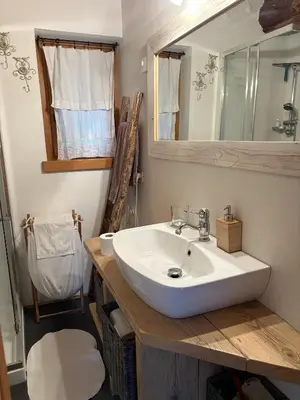 a bathroom with a white sink and a mirror at Il Tabià