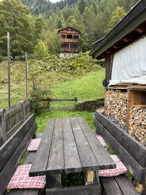 a wooden table sitting next to a building at Il Tabià