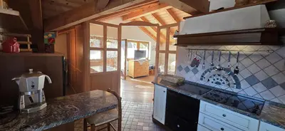 a kitchen with a counter and a stove top oven at Casa dal Cialie in Vigo di Fassa