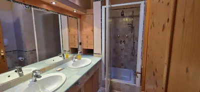 a bathroom with two sinks and a shower at Casa dal Cialie in Vigo di Fassa