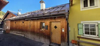 a wooden building with a wooden door on it at Casa dal Cialie in Vigo di Fassa