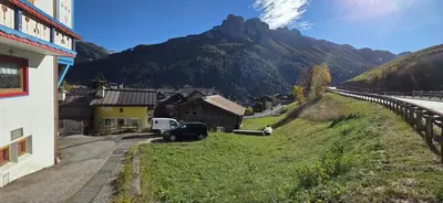 a small village with a mountain in the background at Casa dal Cialie in Vigo di Fassa