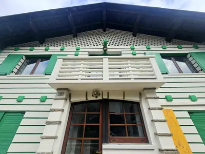 a building with a window and a balcony at Rifugio TEA Dolomiti in Falcade