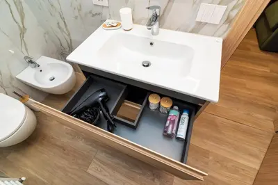 a bathroom with a sink and a toilet at Larice&Ribes Apartments in San Vito di Cadore