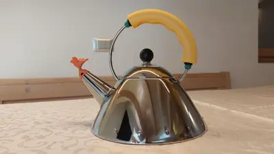 a silver tea kettle sitting on a table at Mansarda Dolores in Canazei