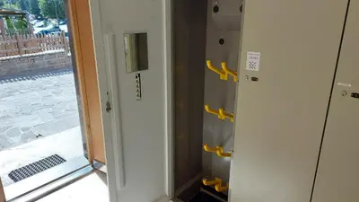 two lockers with yellow handles next to a door at Mansarda Dolores in Canazei