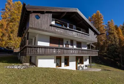 a large house with a balcony on top of a hill at Cortina - Chalet Pocol 22 in Pocol