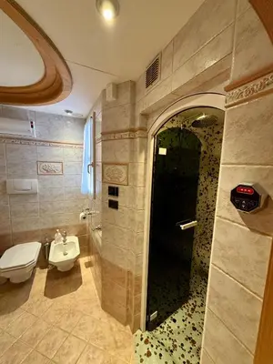 a bathroom with a toilet and a sink at Pragma Apartments - Dolomiti by Valentina in Moena