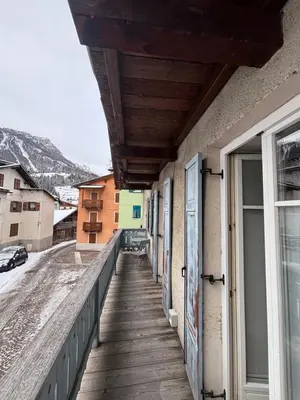 a balcony of a building with a wooden walkway at Pragma Apartments - Dolomiti by Valentina in Moena