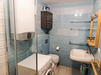 a small bathroom with a toilet and a sink at Apartment Val Fiemme by Interhome in Cavalese