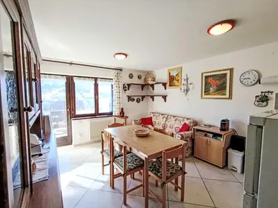 a living room with a table and a couch at Apartment Val Fiemme by Interhome in Cavalese