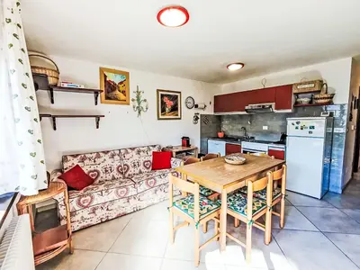 a living room with a table and a couch at Apartment Val Fiemme by Interhome in Cavalese