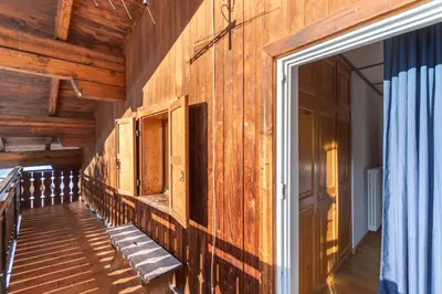an empty room with wooden walls and a doorway at Casa Iris in Falcade