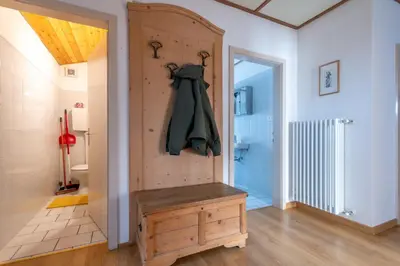 a room with a wooden door with a coat hanging on it at Casa Iris in Falcade