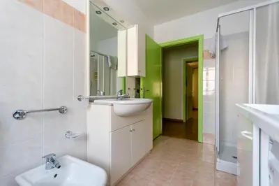 a bathroom with a sink and a toilet at Casa Iris in Falcade