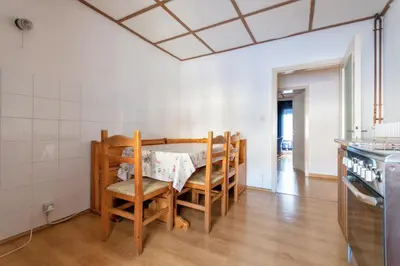 a kitchen with a table and chairs in a room at Casa Iris in Falcade