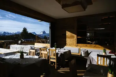 a building with a view of a mountain at Bio Alpine Hotel Gran Fodà in San Vigilio Di Marebbe