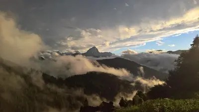 a view of a mountain through a window at Bio Alpine Hotel Gran Fodà in San Vigilio Di Marebbe