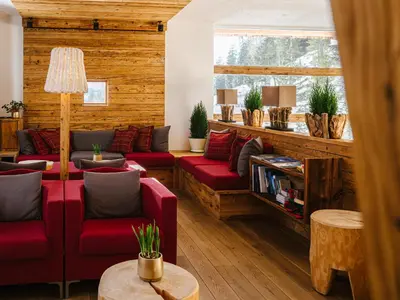 a snow covered mountain with a house on a snow covered slope at Bio Alpine Hotel Gran Fodà in San Vigilio Di Marebbe