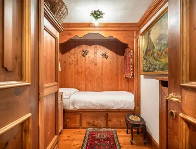 a small room with a small bed in a house at Angiolina Charming Apartment R&R in Cortina dʼAmpezzo