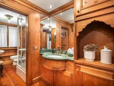 a bathroom with a sink and a glass shower at Angiolina Charming Apartment R&R in Cortina dʼAmpezzo
