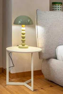 a lamp on a table next to a couch at Cademai Alpenglow Chalet with Sauna R&R in Cortina dʼAmpezzo