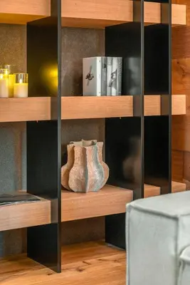 a book shelf with two vases on it at Cademai Alpenglow Chalet with Sauna R&R in Cortina dʼAmpezzo