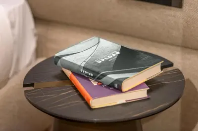 a stack of books sitting on a table at Cademai Alpenglow Chalet with Sauna R&R in Cortina dʼAmpezzo